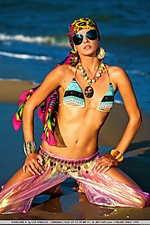 Colorful, vibrant, and enchanting model evoking a sexy sea gypsy by the beach.